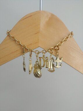 Gold tone charm link bracelet with six charms
